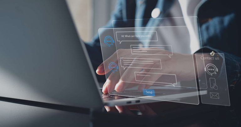 Fingers typing on a keyboard with holographic chat bot